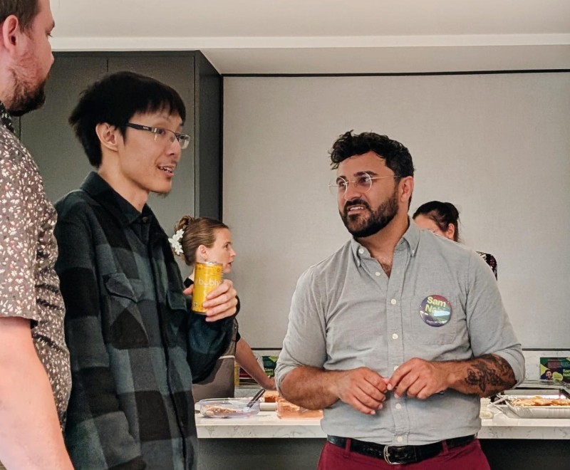 Sam speaks with a constituent at a community conversation